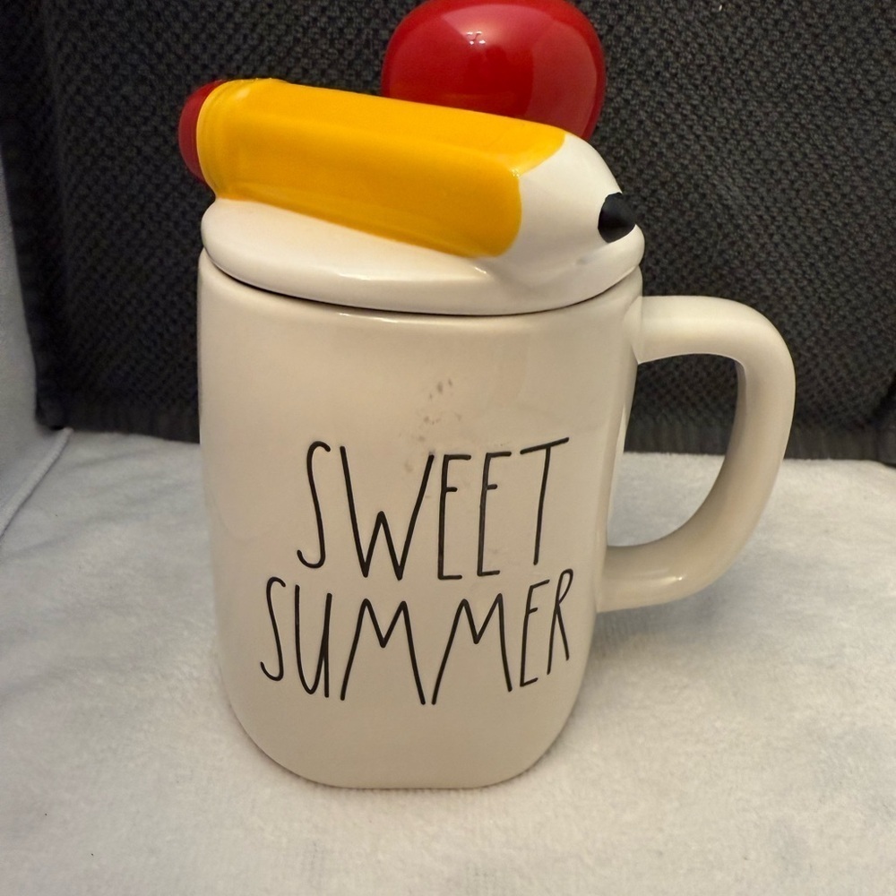 Rae Dunn 'Sweet Summer' mug with a decorative lid.
